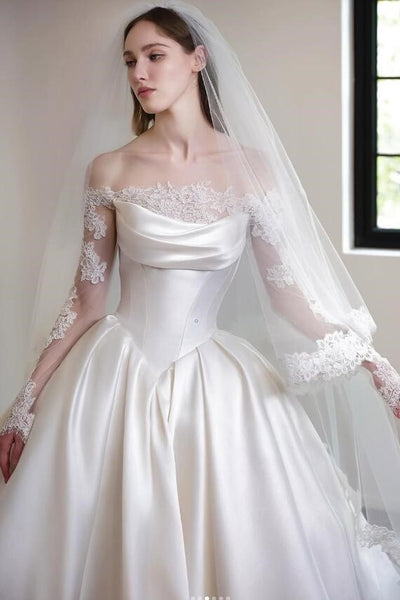 Woman wearing a white wedding dress with lace sleeves