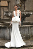 Woman in a white wedding gown with floral details 