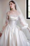 Woman wearing a white wedding dress with lace sleeves