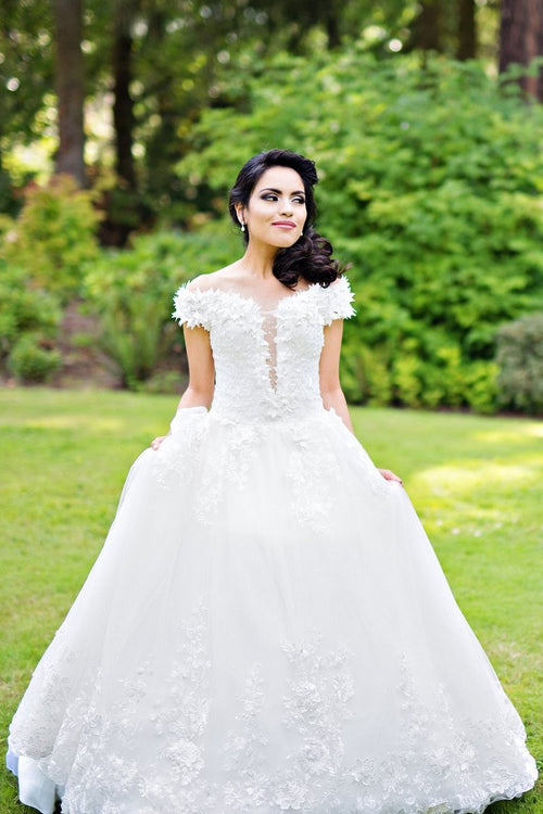 plunging-neckline-white-wedding-gown-with-flower-off-the-shoulder