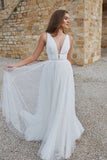 transparent-plunging-white-tulle-wedding-dress-beach